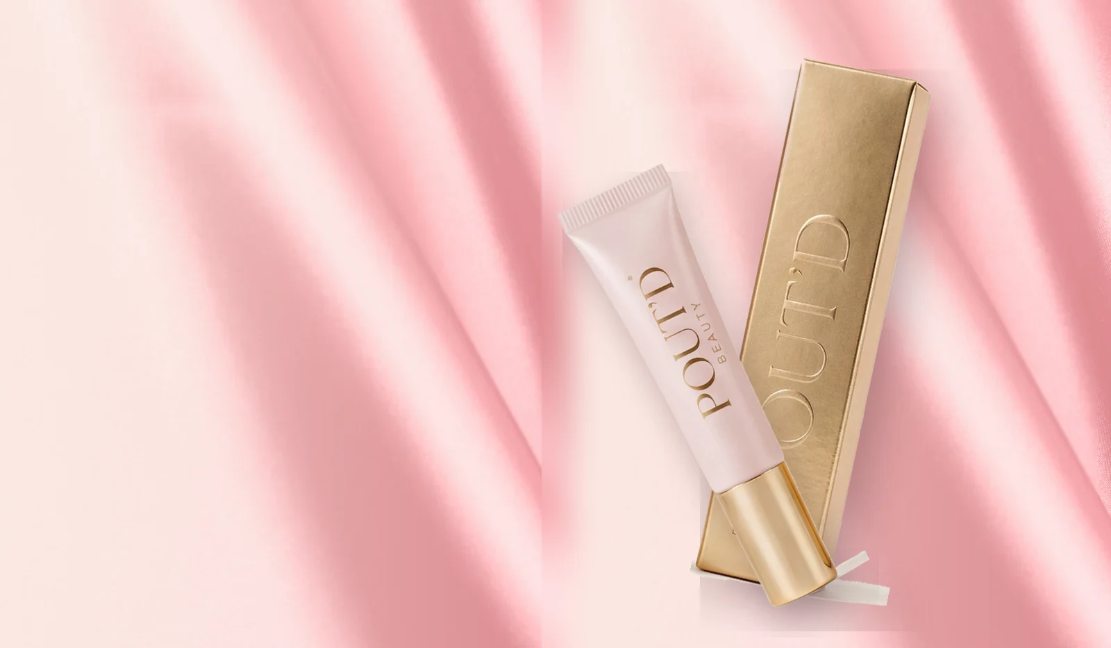Pout'd lip plumper — pink tube and gold box laid on draped pink silk